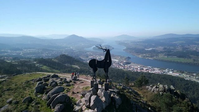 Aerial footage of Vila Nova de Cerveira sightseeing with a statue at the top