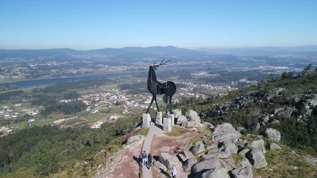 Aerial footage of Vila Nova de Cerveira sightseeing with a statue at the top