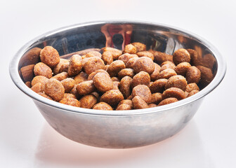  Delicious bowl of dog food balls over isolated white background