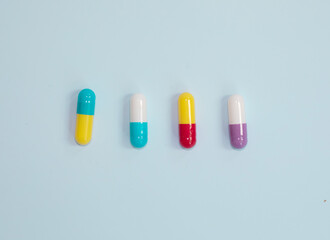 Pharmaceutical medicine pills, tablets and capsules on blue background. Top view. Flat lay. Copy space. Medicine concepts.