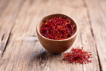Saffron threads on wooden background