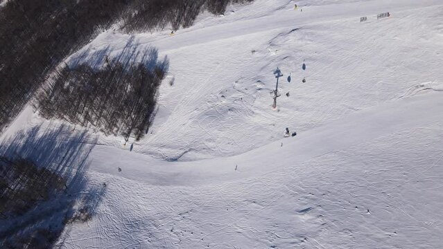 Stara Planina babin Zub Ski track with Gondola type cable car transport Skiers on snow covered slope of ski resort Landscape with snowy piste Aerial drone view old mountain Balkan