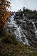 Fototapeta na wymiar The Nardis Waterfall in Trentino Alto Adige during a foggy and rainy day in autumn, Northern Italy