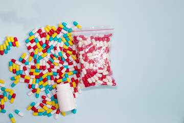 Naklejka premium Different colorful pills on blue background. 
