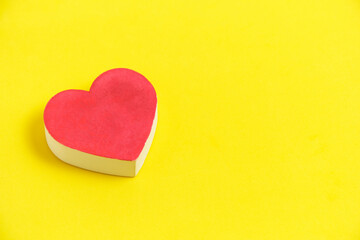 Red heart bright yellow background.