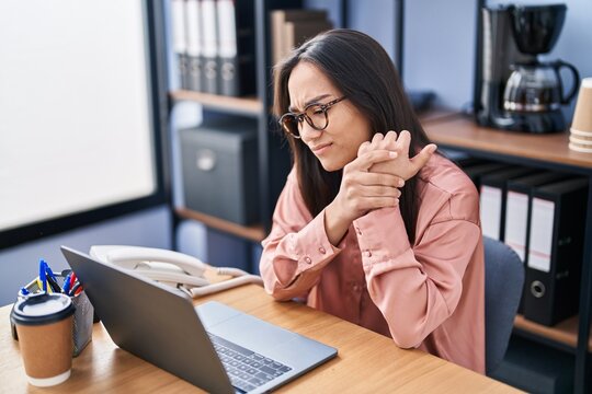 Young Hispanic Woman Business Worker Suffering For Hand Pain At Office