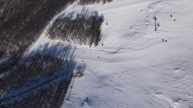 Stara Planina babin Zub Ski track with Gondola type cable car transport Skiers on snow covered slope of ski resort Landscape with snowy piste Aerial drone view old mountain Balkan