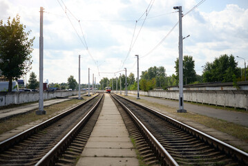 Tram public transport moving on railroad line to the platform 