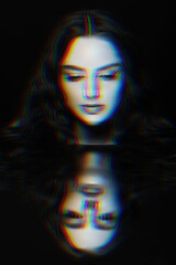 Pop art concept. Woman with long wavy hair sensual studio portrait. Model looking to reflection of her face in mirror. RGB channel color split effect applied. Futuristic looking style