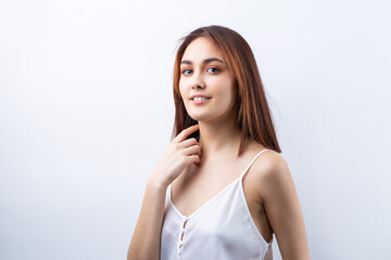 Fototapeta premium Beautiful smiling woman with clean skin, natural make-up and white teeth on a gray background