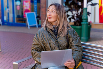 Asian woman student writing in a notebook  in a cafe. concept of study at any age .