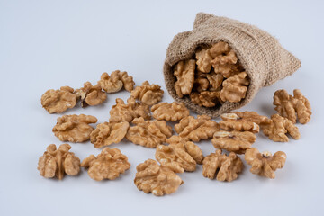 Heap Pecans on A White Background.  A Pile of Walnuts Falling From A Sack
