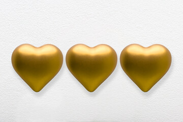 Gold color love hearts on a white blank background