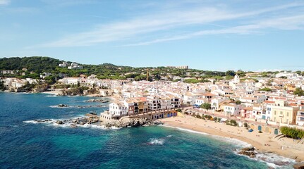 Fototapeta na wymiar aerial view from the Mediterranean Sea on the beautiful seaside town of Calella de Palafrugell at the Costa Brava, fishing village, tourism, Palafrugell, Baix Empordà, Girona, Catalonia, Spain