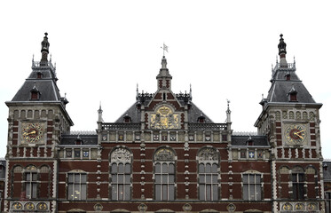 Fototapeta na wymiar Amsterdam Central station building on a clouded day with white sky
