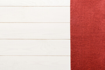 top view with red empty kitchen napkin isolated on table background. Folded cloth for mockup with...