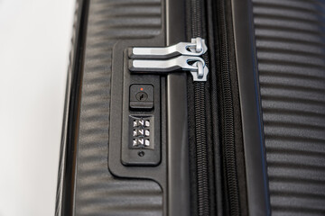 Vertical close-up view of a digital lock and zipper on a suitcase