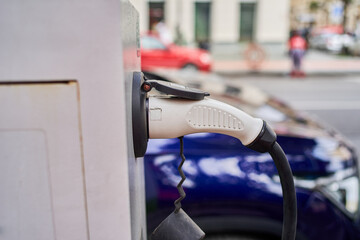 A charger inserted into the socket of a charging station