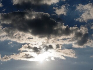 Sunbeams break through dramatic sky with dark clouds