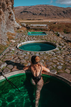 Woman enjoying sunset at Hoffel Hot Tubs, Iceland