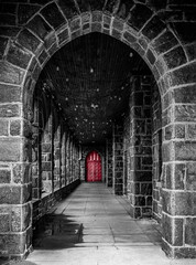red door in stone hall