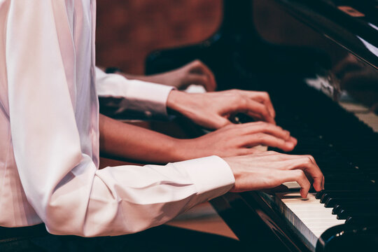 Indoor concert background abstract people playing music instruments in symphony orchestra piano dual performance arts rehearsals chamber music