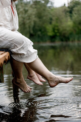 female feet splashing in river water
