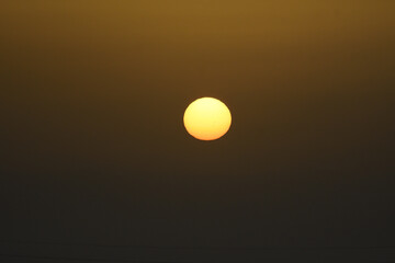 The sun at dawn through the mist