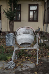 Used concrete mixer. Hand concrete mixer at a construction place