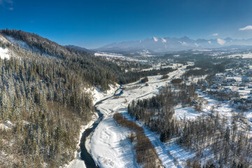 Winter panorama of Bialka Tatrzanska  on the Bialka river.  On the background Tatra Mountains. Podhale, Poland.