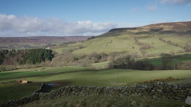 Cloud Shadows sweeping gracefully over fields and steep slopes in Farndale North York Moors