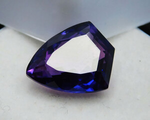 Natural gemstone purple amethyst on gray background