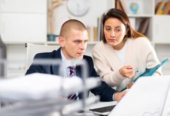 Businessman and businesswoman working together at office