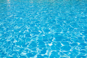 Pure blue water background. Outdoor swimming pool