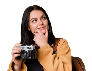 Young woman, smiling, with film camera, looking through viewfinder, excited by new passion