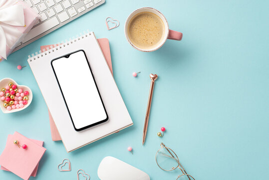 8-march concept. Top view photo of keyboard smartphone notepads pen heart shaped saucer pushpins clips sticky note paper giftbox glasses mug of coffee on isolated pastel blue background with copyspace