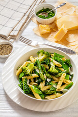 Pasta primavera with green veggies, cheese in bowl