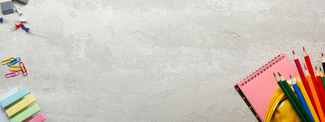 Back to school concept. School supplies on black board background.