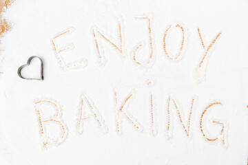 background wooden baking board with flour frame and baking aaccessories