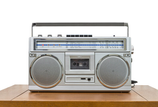 Vintage boombox on wood table with cut out background