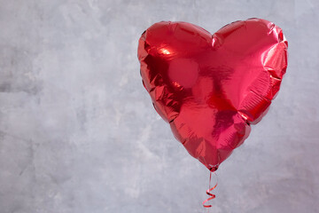 red balloon in the shape of a heart on a gray background. valentine's day gift