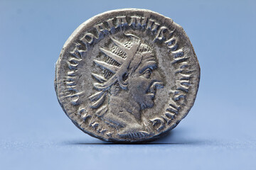 Isolated Roman coin of caesar Trajan Decius Antoninianus with blue background