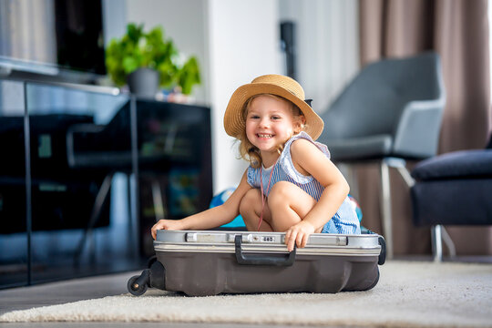 Little girl in suitcase baggage luggage ready to go for traveling on vacation