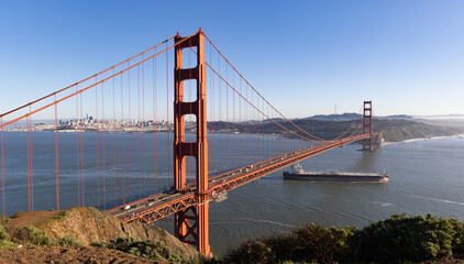  A cargo ship passes under the Golden Gate Bridge