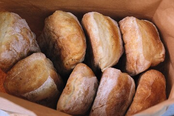 freshly baked bread in craft bags. Home baked whole grain bread. Crusty sourdough loaf of wheat bread with wholegrain flour.	
