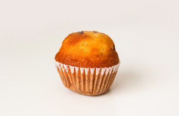 Sweet muffin cup cake closeup on white background.
