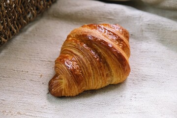 freshly baked croissant on a tablecloth	