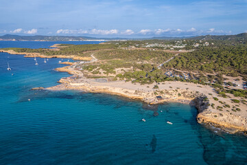 Aerial photographs of the beaches of Cala Conta and Cala Escondida, on the island of Ibiza during a sunny summer day with blue sky and turquoise water