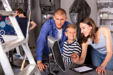 Portrait of a friendly family at a computer, thinking about solving a puzzle in a quest room, stylized as a laboratory