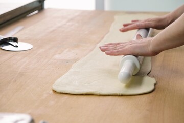 the process of making Grissini. grissini with olives and thyme recipe. cook cuts grissini. baker at work. The baker shapes the bread. Hands on the close-up foruyut bread